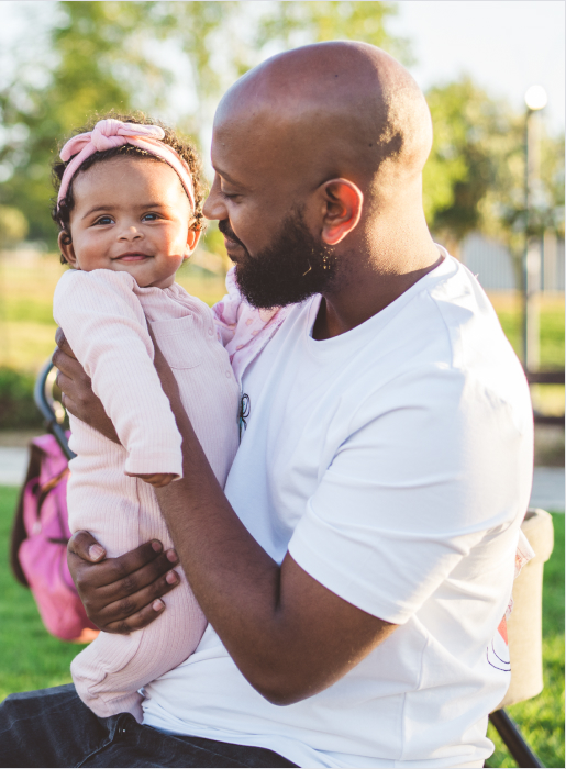 Father holding his baby and smiling