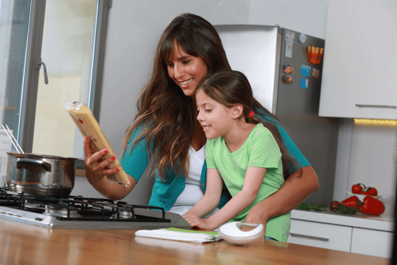 A woman and a girl are looking at a food product.