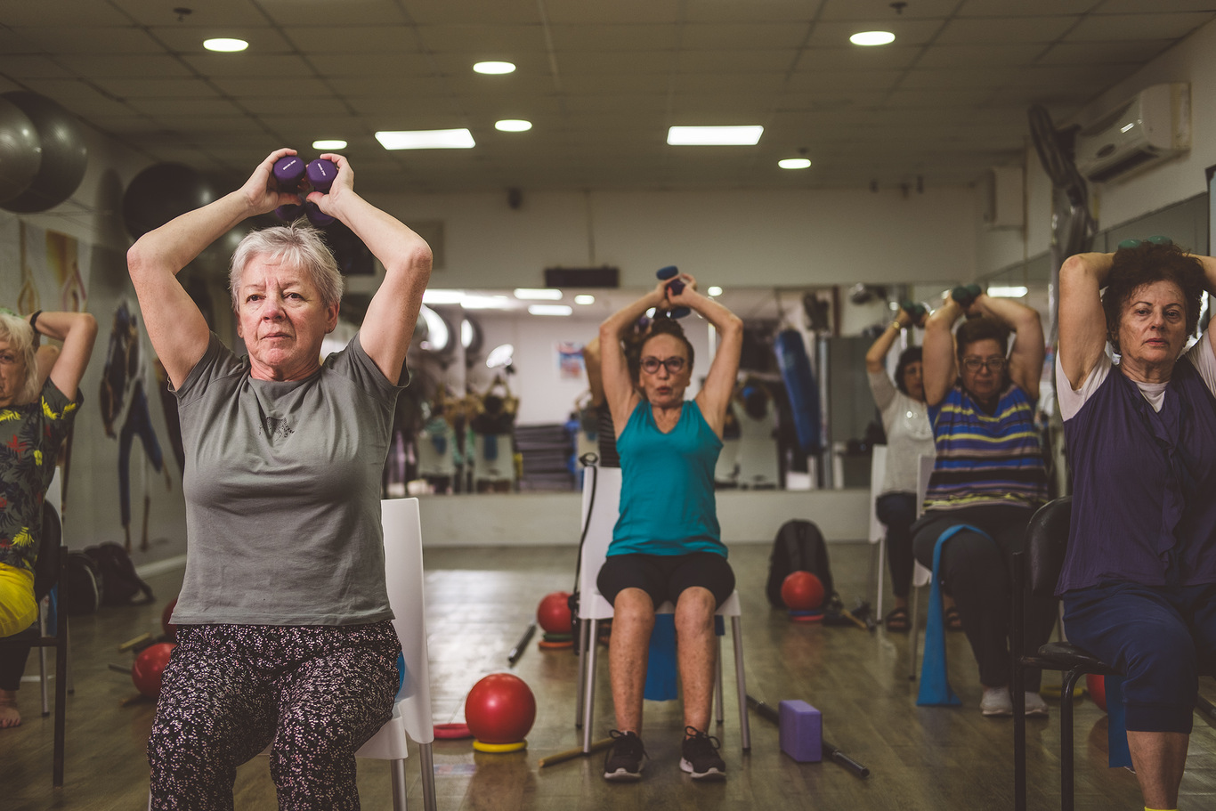 Women are exercising with dumbbells.