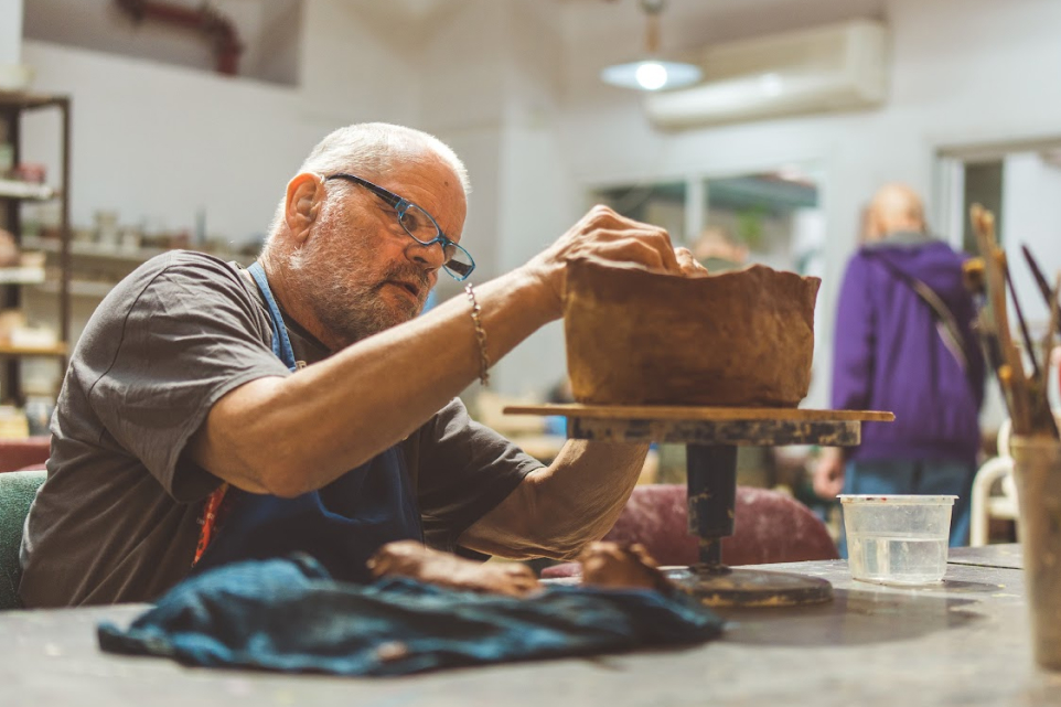 Elderly man using clay